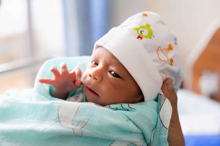 newborn baby looking at the cameraの写真素材