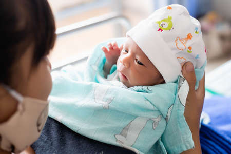 newborn baby looking at the cameraの写真素材