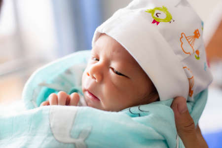 newborn baby looking at the cameraの写真素材