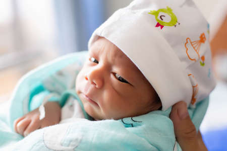newborn baby looking at the cameraの写真素材