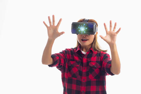 Portrait of a young beautiful woman with VR goggles in studio