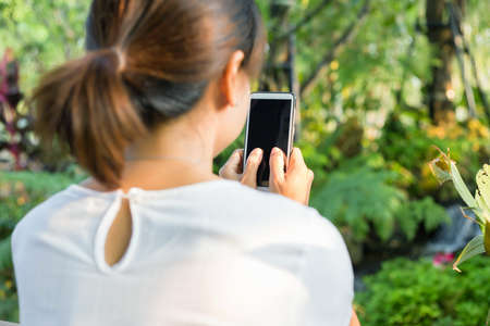 Women texting on smartphone in cafe close up on handの写真素材