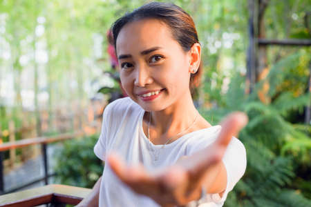 Hand of Young Woman Enjoying Nature with sunrise.の写真素材