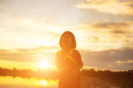 kid silhouette,Moments of the child's joy. On the Nature sunsetの写真素材