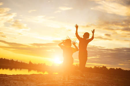 kid silhouette,Moments of the child's joy. On the Nature sunsetの写真素材