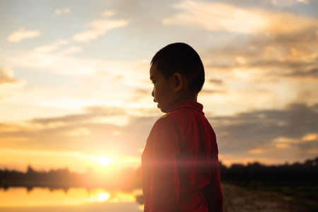 kid silhouette,Moments of the child's joy. On the Nature sunsetの写真素材