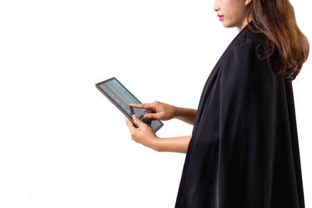 Asian businesswoman standing and crossing her arms in office building hallway stock photoの写真素材