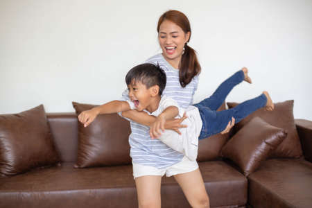 happy asian family at living room,happiness time of family playing at home,dad Mom and baby are happiness coexistence,happy family concept and Creating activities to strengthen skills for children.の写真素材