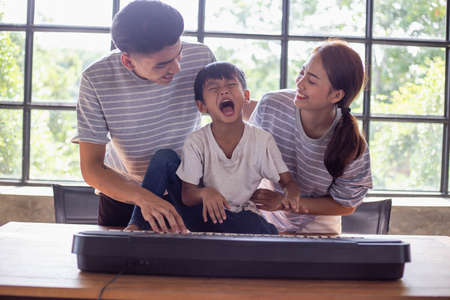 happy asian family at living room,happiness time of family playing at home,dad Mom and baby are happiness coexistence,happy family concept and Creating activities to strengthen skills for childrenの写真素材