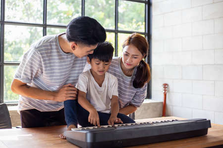 happy asian family at living room,happiness time of family playing at home,dad Mom and baby are...