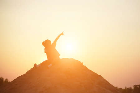 kid silhouette,Moments of the child's joy. On the Nature sunsetの写真素材