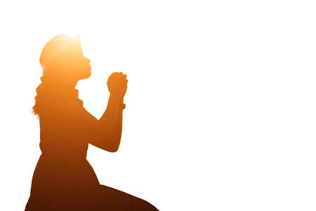 Silhouette of woman praying over beautiful sky backgroundの写真素材