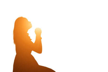 Silhouette of woman praying over beautiful sky backgroundの写真素材