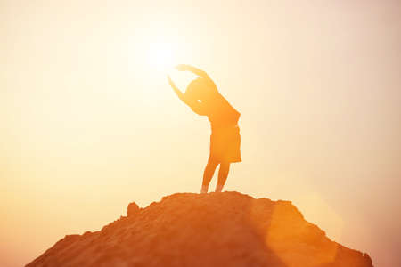 kid silhouette,Moments of the child's joy. On the Nature sunsetの写真素材