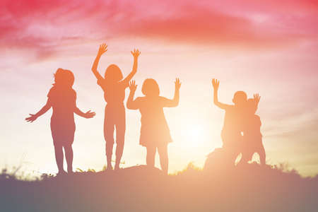 silhouette of a happy children and happy time sunsetの写真素材