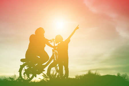 silhouette of a happy children and happy time sunsetの写真素材