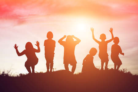 silhouette of a happy children and happy time sunsetの写真素材