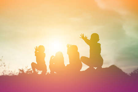 silhouette of a happy children and happy time sunsetの写真素材