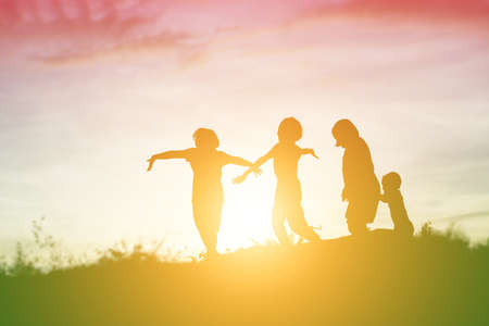 silhouette of a happy children and happy time sunsetの写真素材