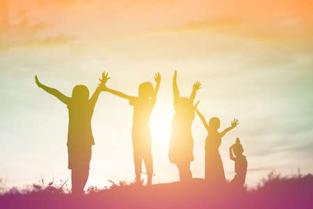 silhouette of a happy children and happy time sunsetの写真素材