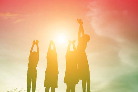 silhouette of a happy children and happy time sunsetの写真素材