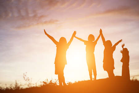 silhouette of a happy children and happy time sunsetの写真素材