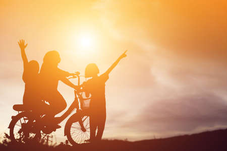 silhouette of a happy children and happy time sunsetの写真素材