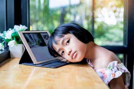 Happy kids using a laptop computer at homeの写真素材