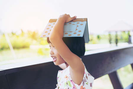 The happy schoolgirl sitting at the desk with booksの写真素材