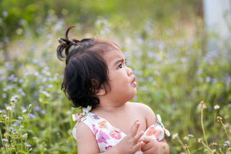 Cute girl smiling brightly in the setting sunの写真素材