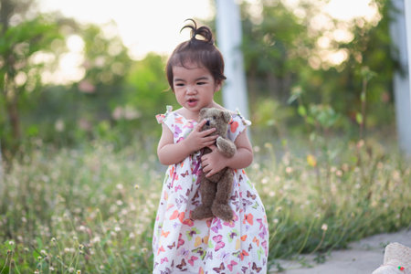 Cute girl smiling brightly in the setting sunの写真素材