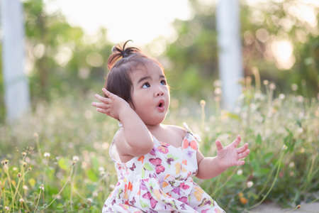 Cute girl smiling brightly in the setting sunの写真素材