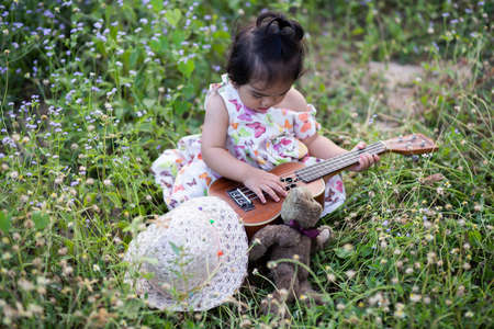 Cute girl smiling brightly in the setting sunの写真素材