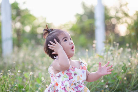 Cute girl smiling brightly in the setting sunの写真素材