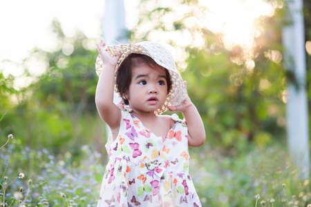 Cute girl smiling brightly in the setting sunの写真素材