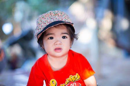 Cute girl smiling brightly in the setting sunの写真素材