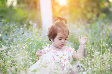 Cute girl smiling brightly in the setting sunの写真素材