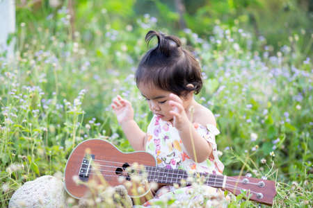 Cute girl smiling brightly in the setting sunの写真素材