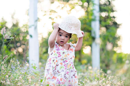 Cute girl smiling brightly in the setting sunの写真素材
