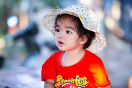 Cute girl smiling brightly in the setting sunの写真素材