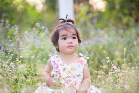 Cute girl smiling brightly in the setting sunの写真素材