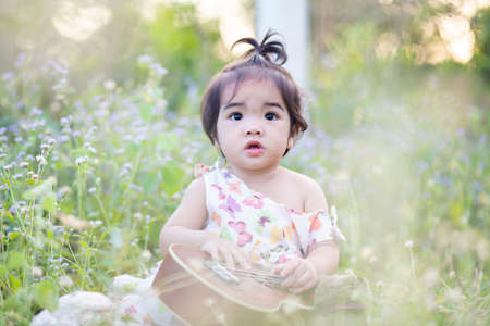 Cute girl smiling brightly in the setting sunの写真素材