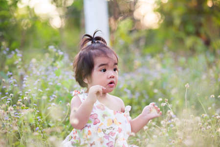 Cute girl smiling brightly in the setting sunの写真素材