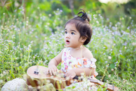 Cute girl smiling brightly in the setting sunの写真素材