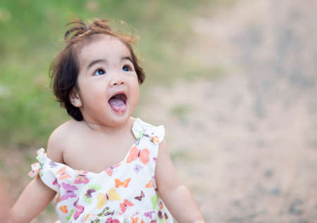Cute girl smiling brightly in the setting sunの写真素材