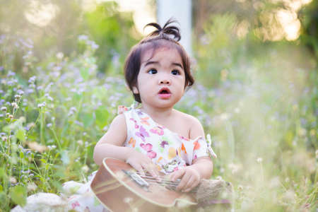 Cute girl smiling brightly in the setting sunの写真素材
