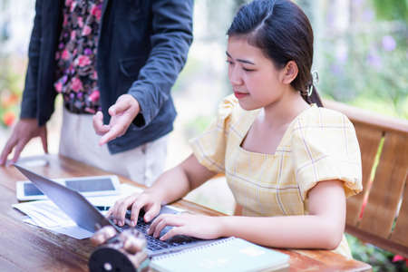 Image of document with charts on background of male and female working , business conceptの写真素材