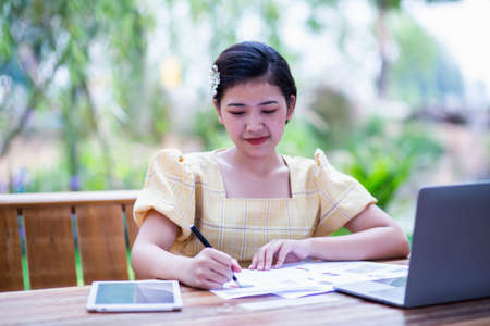 Image of document with charts on background of male and female working , business conceptの写真素材