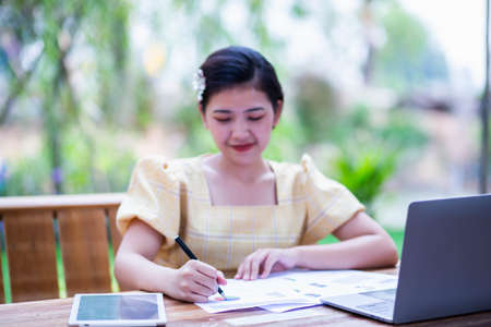 Image of document with charts on background of male and female working , business conceptの写真素材