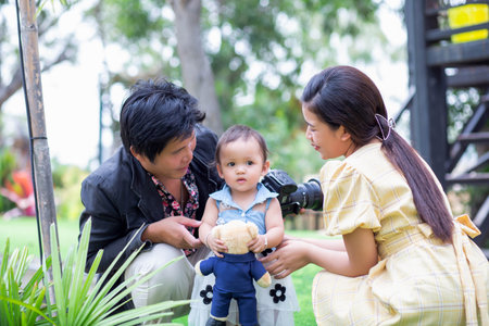 Happy mother and daughter walking in the gardenの写真素材